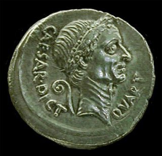 Caesar was the first living Roman to have his own portrait on a coin. Silver denarius of Julius Caesar, 44 BC. The inscription CAESAR DICT QUART refers to his being dictator four times. The curved symbol is a lituus, the staff used by augurs which here signifies his office of pontifex maximus. (VRoma: Museum of Fine Arts, Boston: Barbara McManus) 